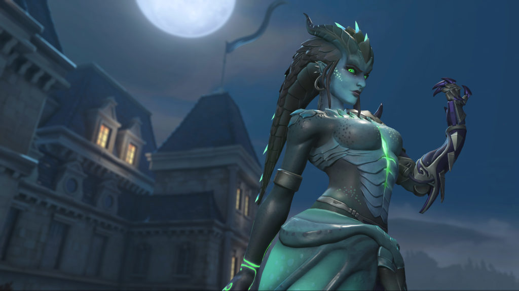 Symmetra stands in front of Chateau Guillard in a green dragon-inspired skin.