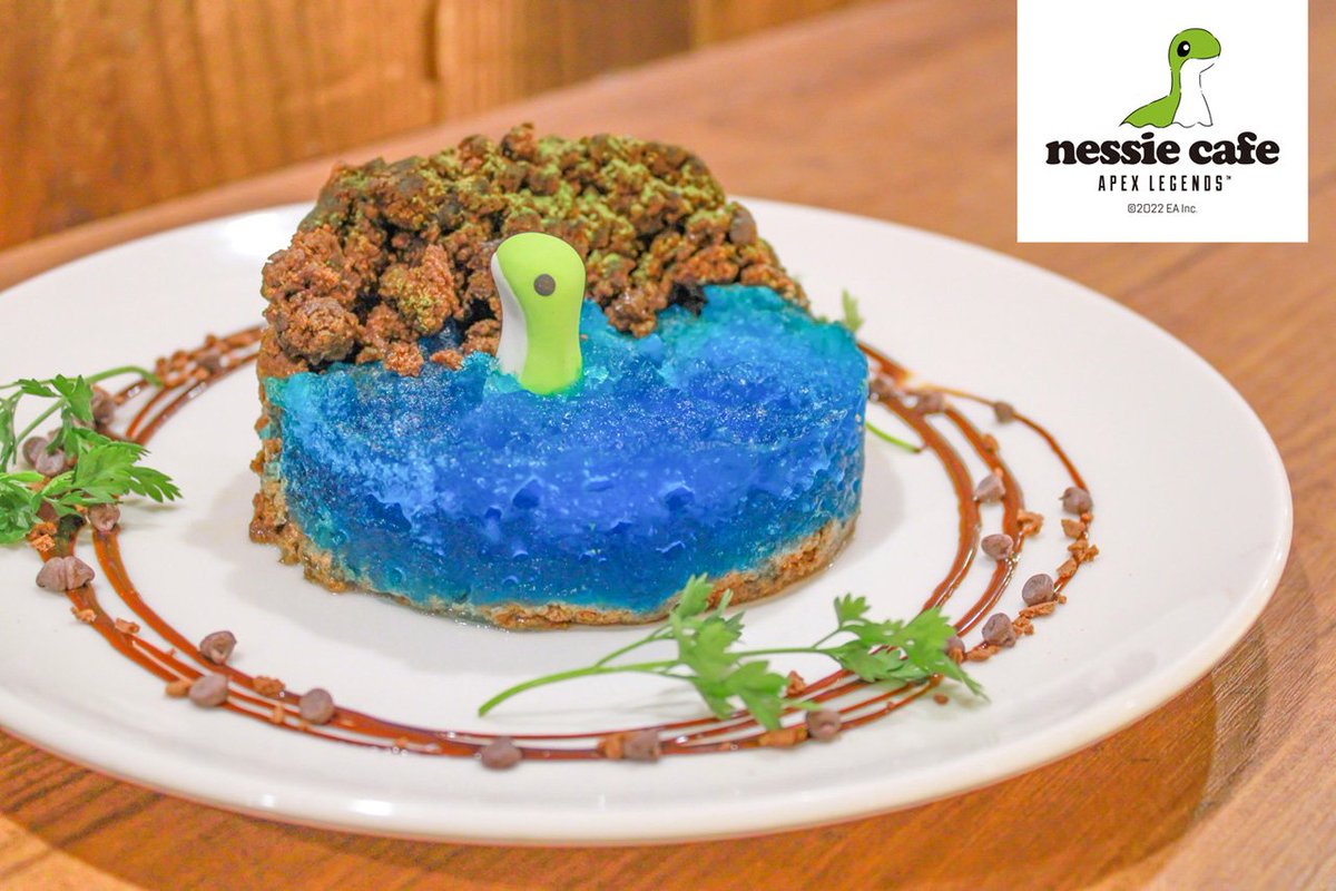A Nessie pokes its head out of a blue cake.