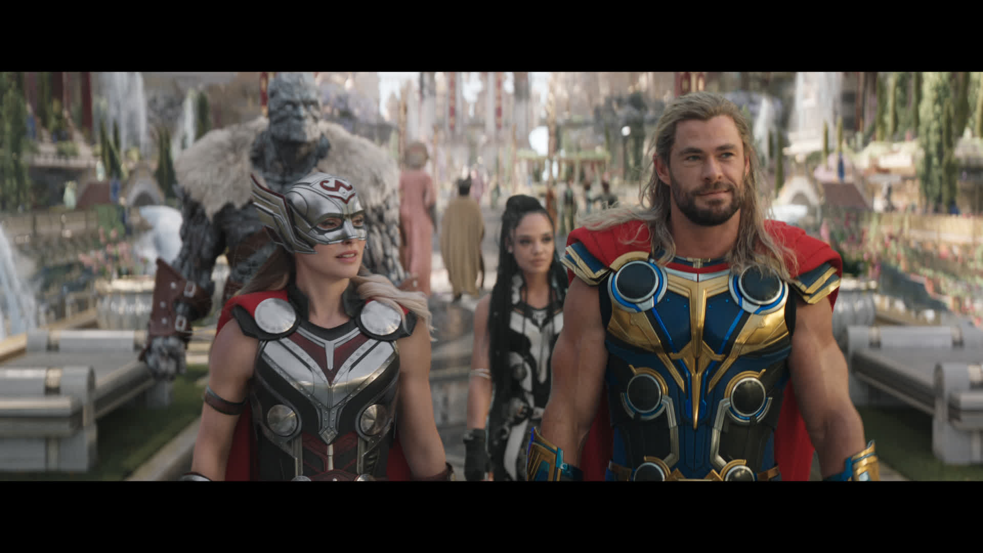 Jane Foster and Thor walk next to each other, followed by companions