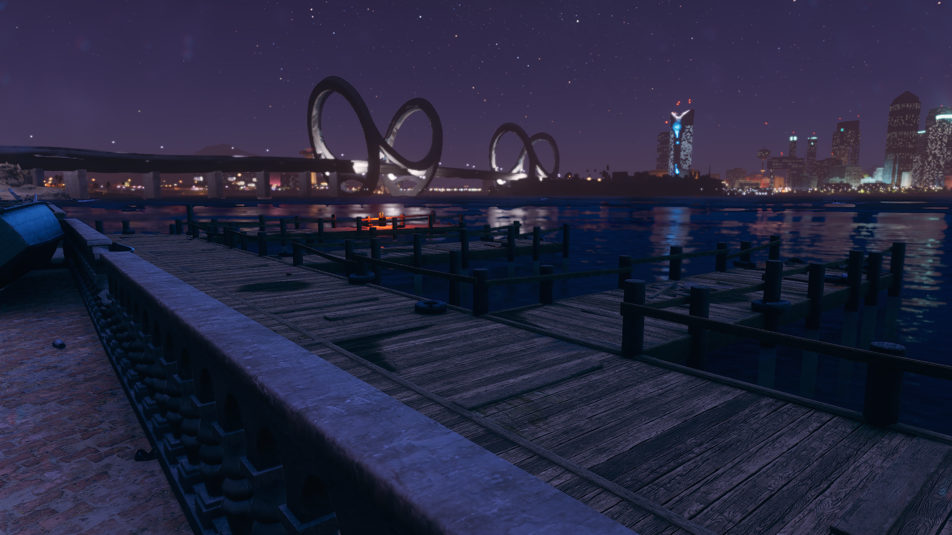 Wooden docks with large illuminated bridge in the background